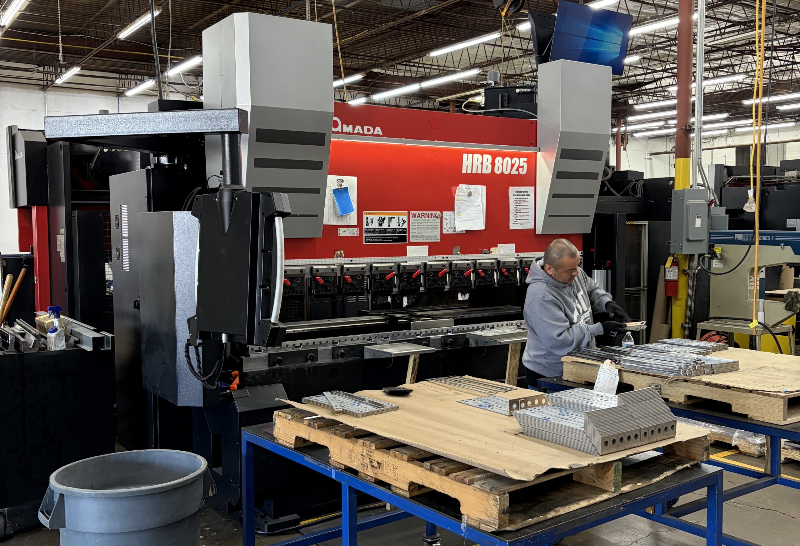 AST Manufacturing operator working at new Amada press brake